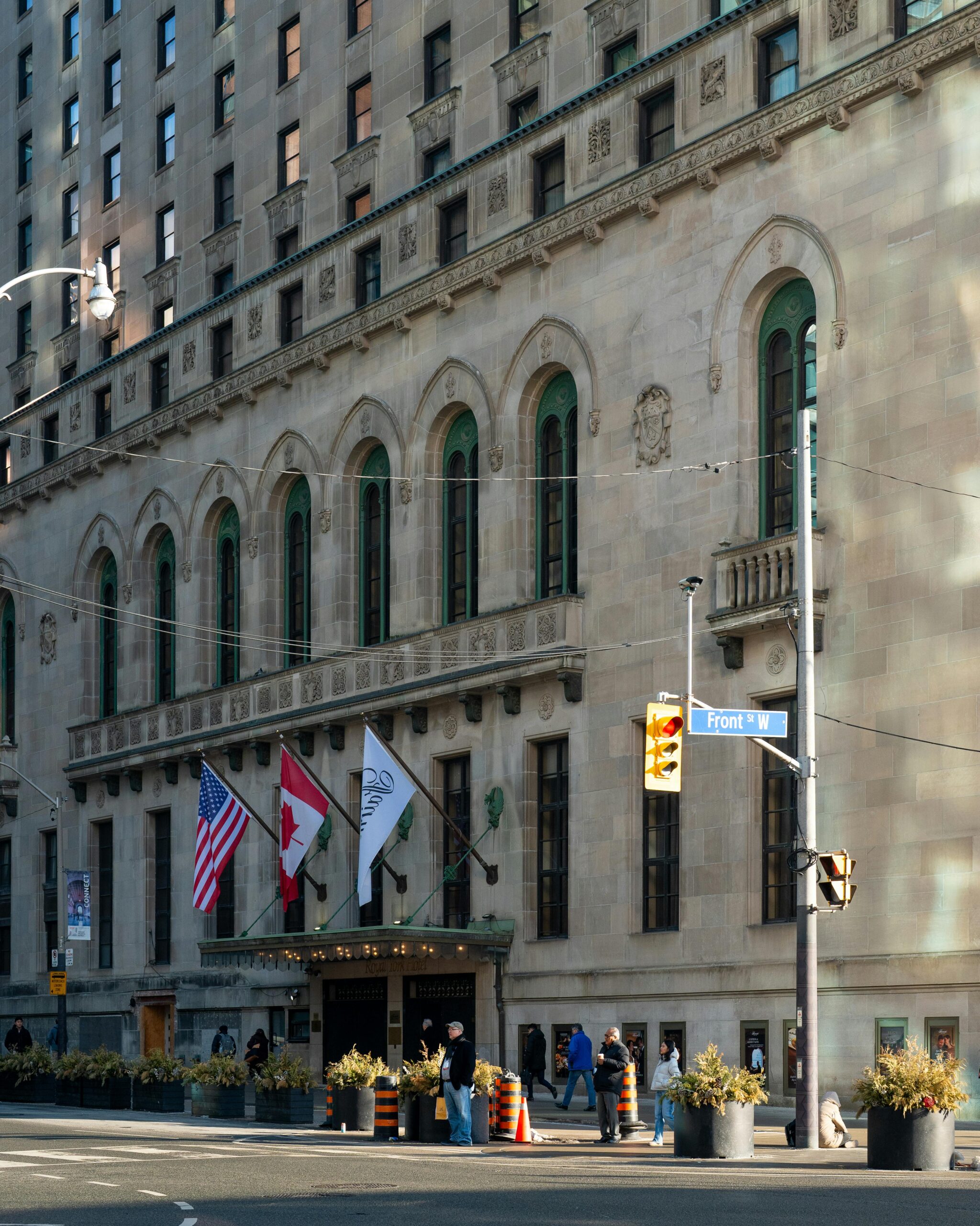 Stunning view of the historic Fairmont Royal York Hotel with flags and architectural details in Toronto, Canada.